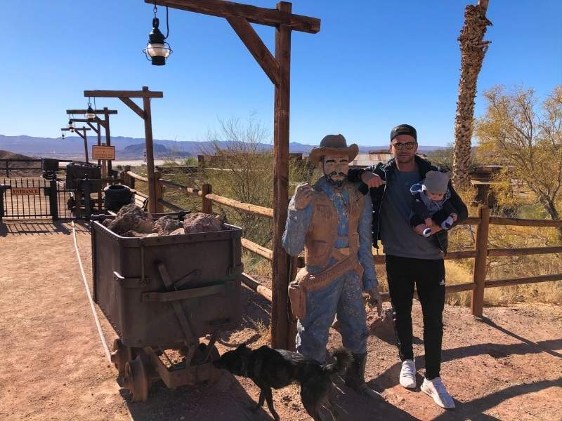 Muž pozuje s umělou postavou kovboje v Calico Town.