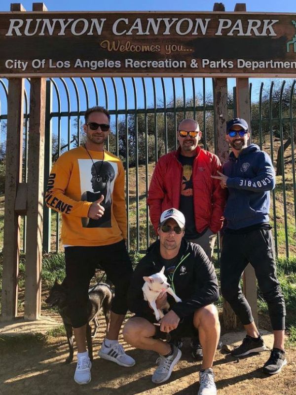 Runyon Canyon Park s čtyřmi muži, kteří pózují před bránou